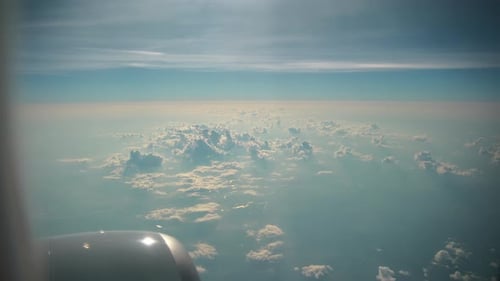 Blue Sky and Big White Clouds Wide View From the Airplane Porthole
