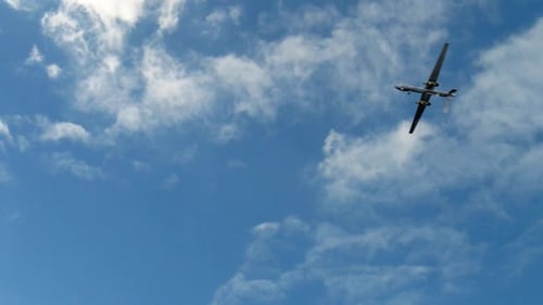 Drone Flies in Blue Cloudy Sky