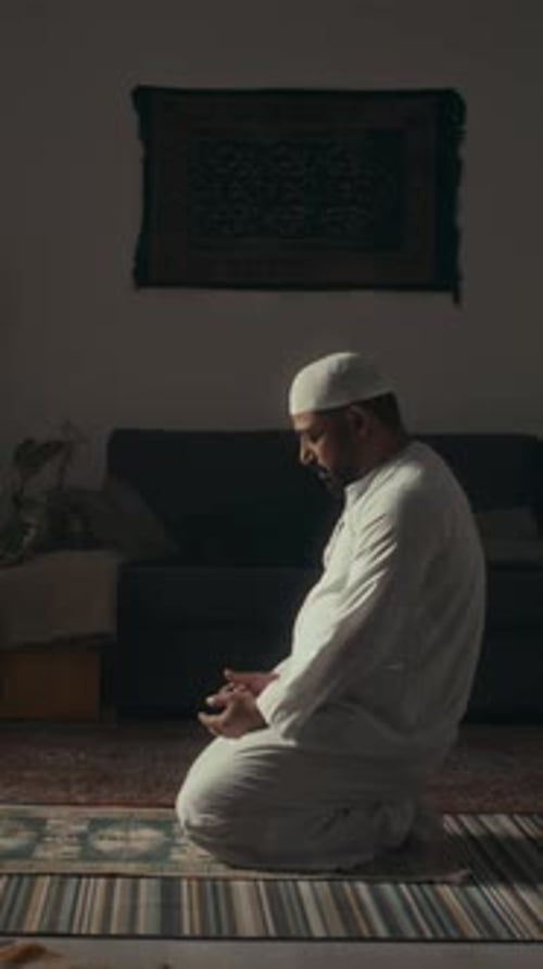 Man Kneels and Prays Indoors