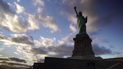 Statue of Liberty shaded at eventide. Liberty Island in New York City, United States. Panning right,
