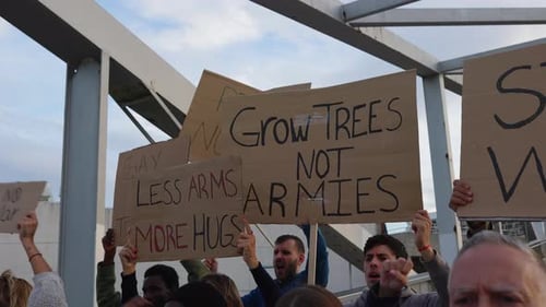 People Marching With Signs On City Street