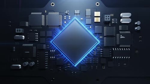 Un bras robotique insère un processeur sur une carte de circuit imprimé.
