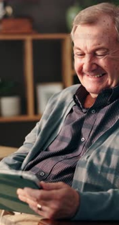 Senior Man Using Tablet Indoors