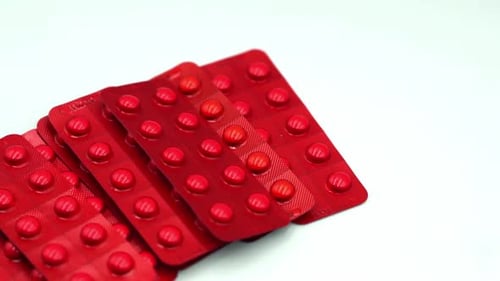 Blister Packs of Red Round Pills on White