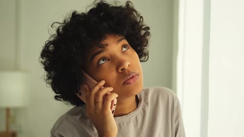 Woman Smiling While Talking on Cell Phone
