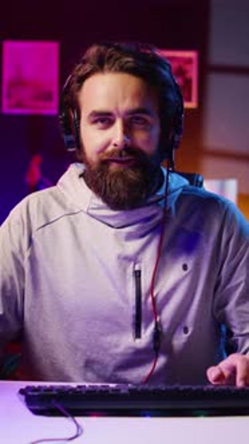 Young Adult With Headphones Using Keyboard