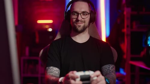 Smiling Gamer with Controller in Neon Lit Room