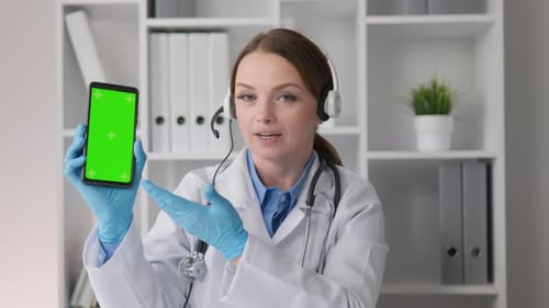 Doctor Holding Phone with Green Screen During Telehealth Visit