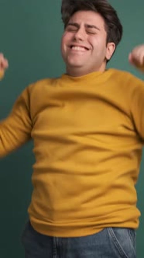 Upset Man Making Blah Blah Gesture in Green Studio