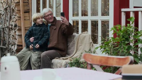 Grandfather and Grandson Smiling and Taking Selfie