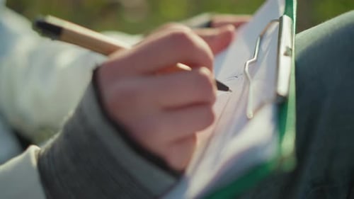 Focused Young Person Creating Artwork with Pen Under Sunlight Young Teenager Passionately