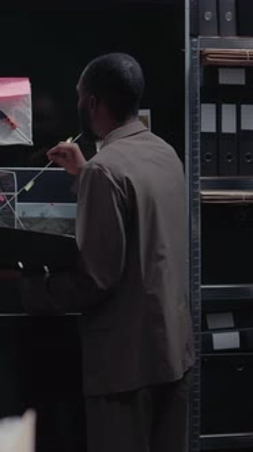 Detective Reviews Evidence and Makes Notes