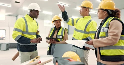 Construction Workers Reviewing Plans on Site