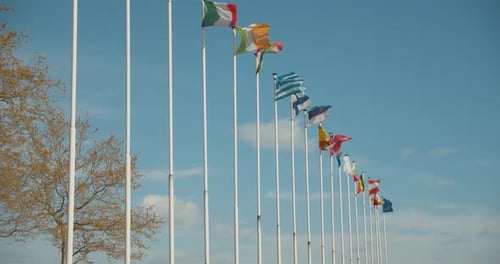 Country Flags Fluttering in the Breeze on Sunny Day