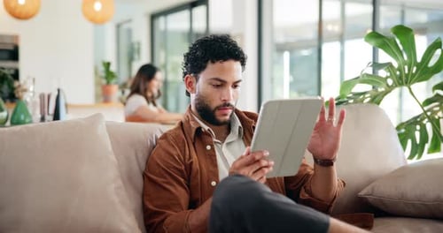 Reading, relax and tablet with man on sofa for social media post, smile and online update