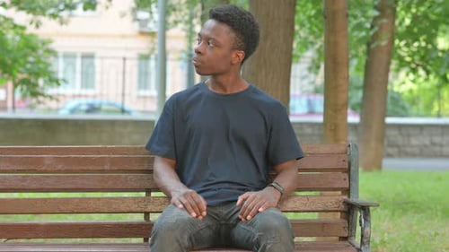 Waiting Casual African Man Checking Wrist Watch on Park Bench