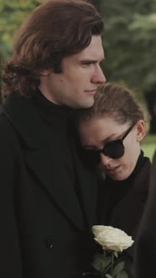 Woman Leans on Man Holding Rose in Nature
