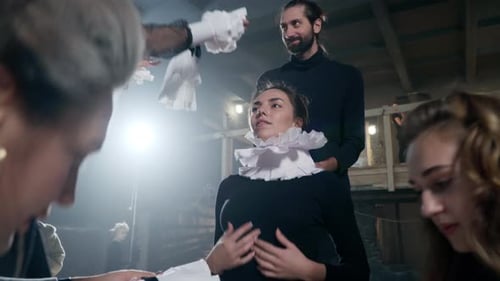 People dressing in ruffled historical costumes