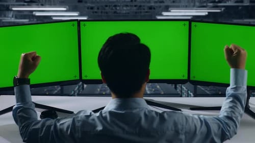 Happy Man Celebrating While Working With Mock Up Multiple Computer Monitor In Data Center