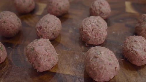 Fresh meatballs on wooden cut board. Close up shot.
