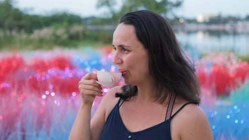 Woman Drinking Beverage Outside