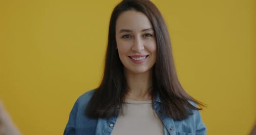 Woman Poses with Donuts in front of Eyes