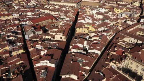 Aerial panning up revealing Cathedral of Santa Maria del Fiore and city on a sunny day in Florence i