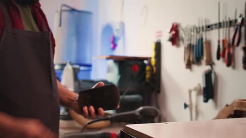 Craftsman Working in Workshop with Tools and Supplies