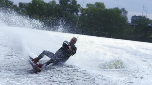 Wakeboarder falling into water during river training session in slow motion