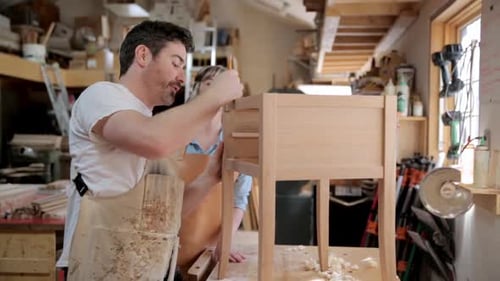 Carpenters Using Tool on Wood Side Table in Workshop 3539 Years
