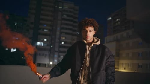 Man Holding Red Grenade in Dark Town Late Evening Guy Burning Colorful Smoke