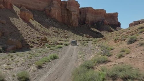 Vehicle Drive On The Rough Road Along Charyn Canyon National Park, Kazakhstan, Central Asia. Aerial