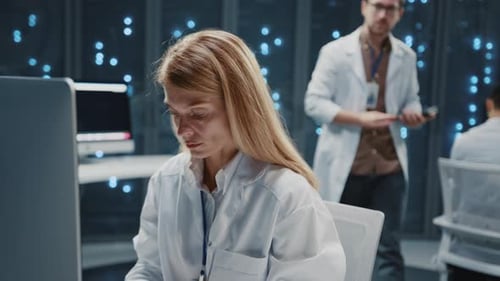 Focused Scientists Working with Technology in a Workplace