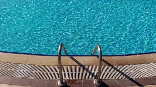 Swimming Pool Water, Sunbeds in Slow Motion