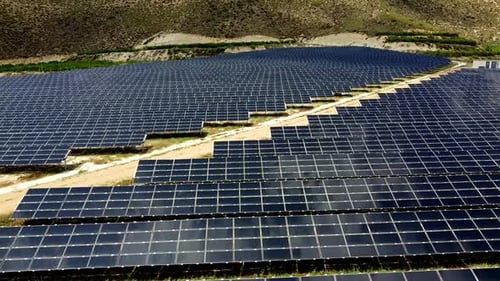 Solar panels farm aerial view from drone shot while sun setting Small photovoltaic cell panels field