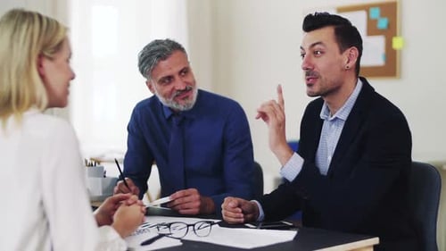 Diverse business team collaborating on laptop in modern office space