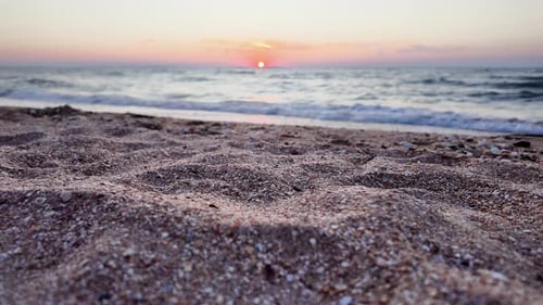 Witness the serene beauty of the sunset casting vibrant colors over the Sea of Azov, with gentle wav