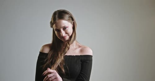 Flirty Young Woman Touching Hair