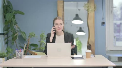 Woman Talking on the Phone While Working