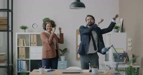 Loop of Playful Businesspeople Colleagues Dancing Smiling Looking at Camera in Modern Office Room