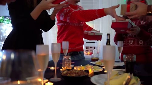 Friends Exchange Christmas Gifts at Festive Gathering