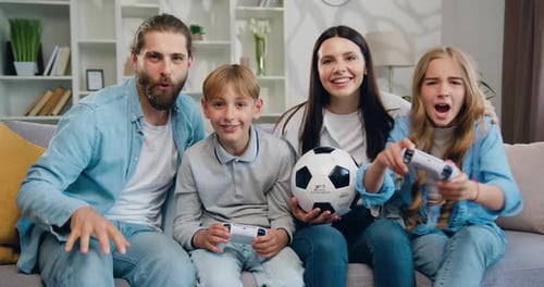 Happy Family Playing Video Games Together at Home
