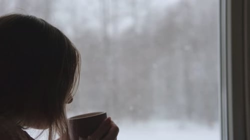 Long Hair Woman Standing Among the Window and Drinking Hot Tea From Mug Winter Landscape Lady Drinks