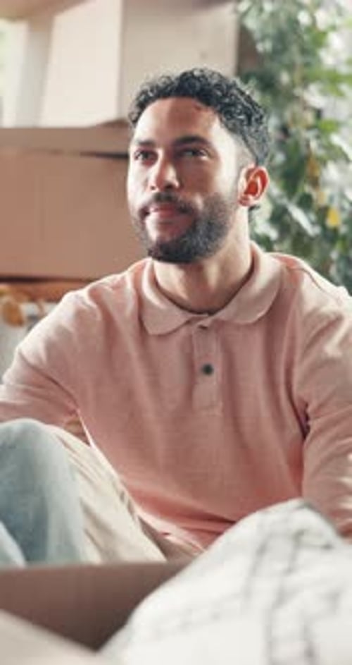 Man, relax and talking with boxes in new house for real estate, property investment and moving in