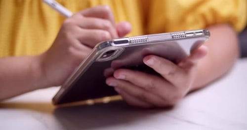 Person Using Stylus on Tablet Close Up