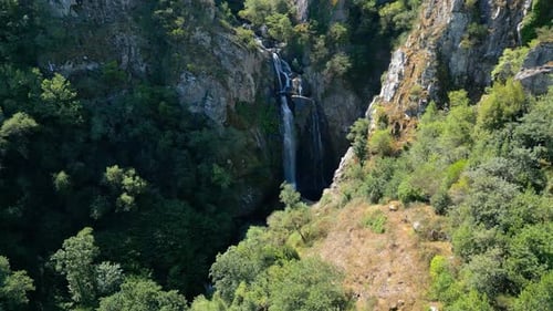 Picturesque Waterfall Flowing Down Mountain Cliffs