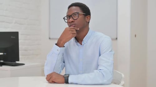 Thoughtful Man Ponders Problem in Office Setting