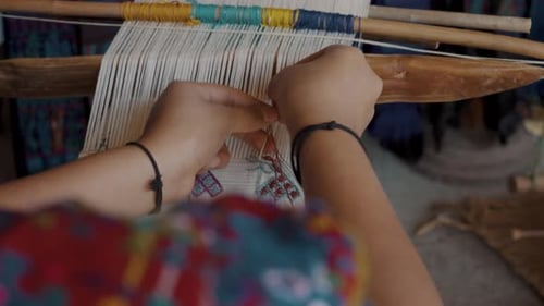 Woman Hands Weaving Cloth Using Backstrap Loom - Close Up