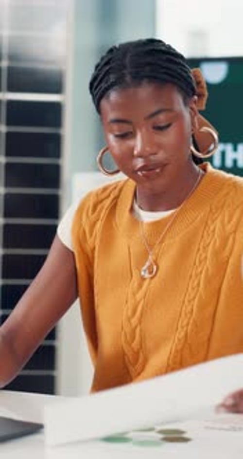 Black woman, laptop and document with solar panel chart, data analysis and renewable energy