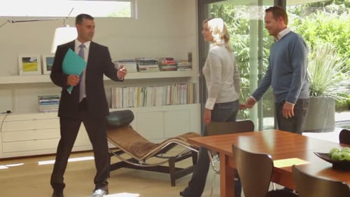 Wide, Track shot off estate agent showing modern house for sale to couple